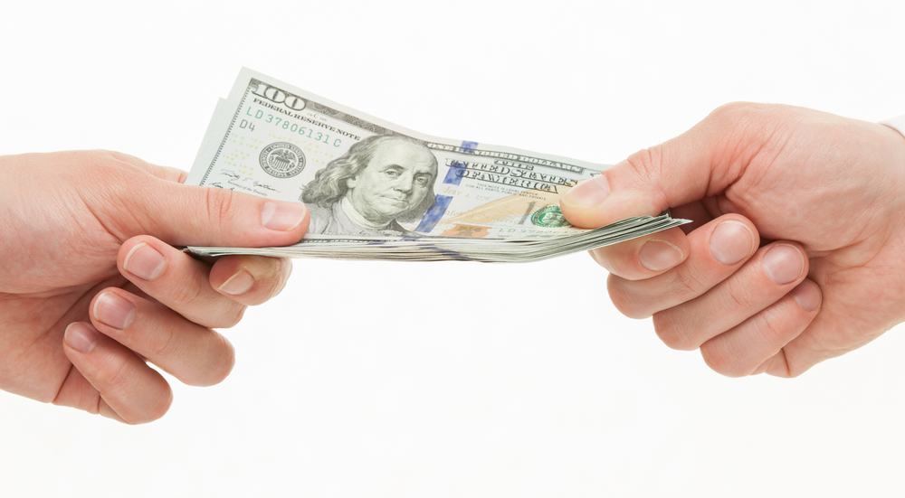 Businesspeople's hands holding dollars, white background